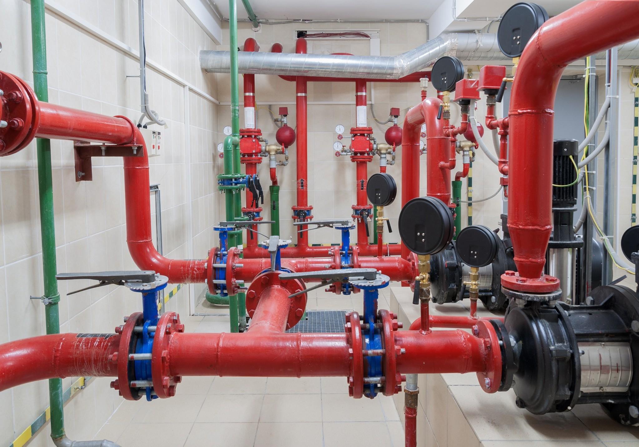 Commercial fire sprinkler riser room with pumps and control valves