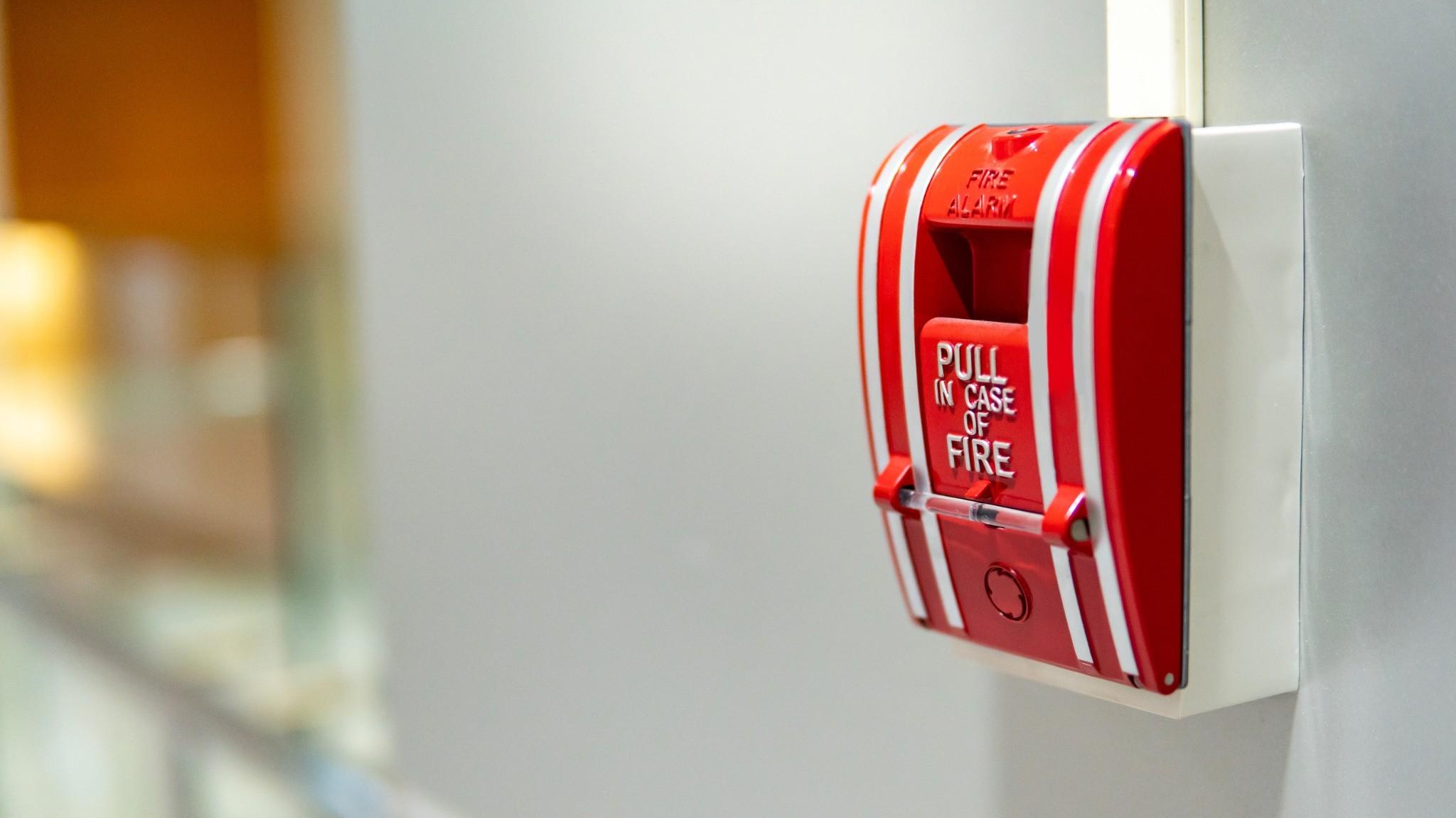 Manual fire alarm pull station installed in a commercial hallway