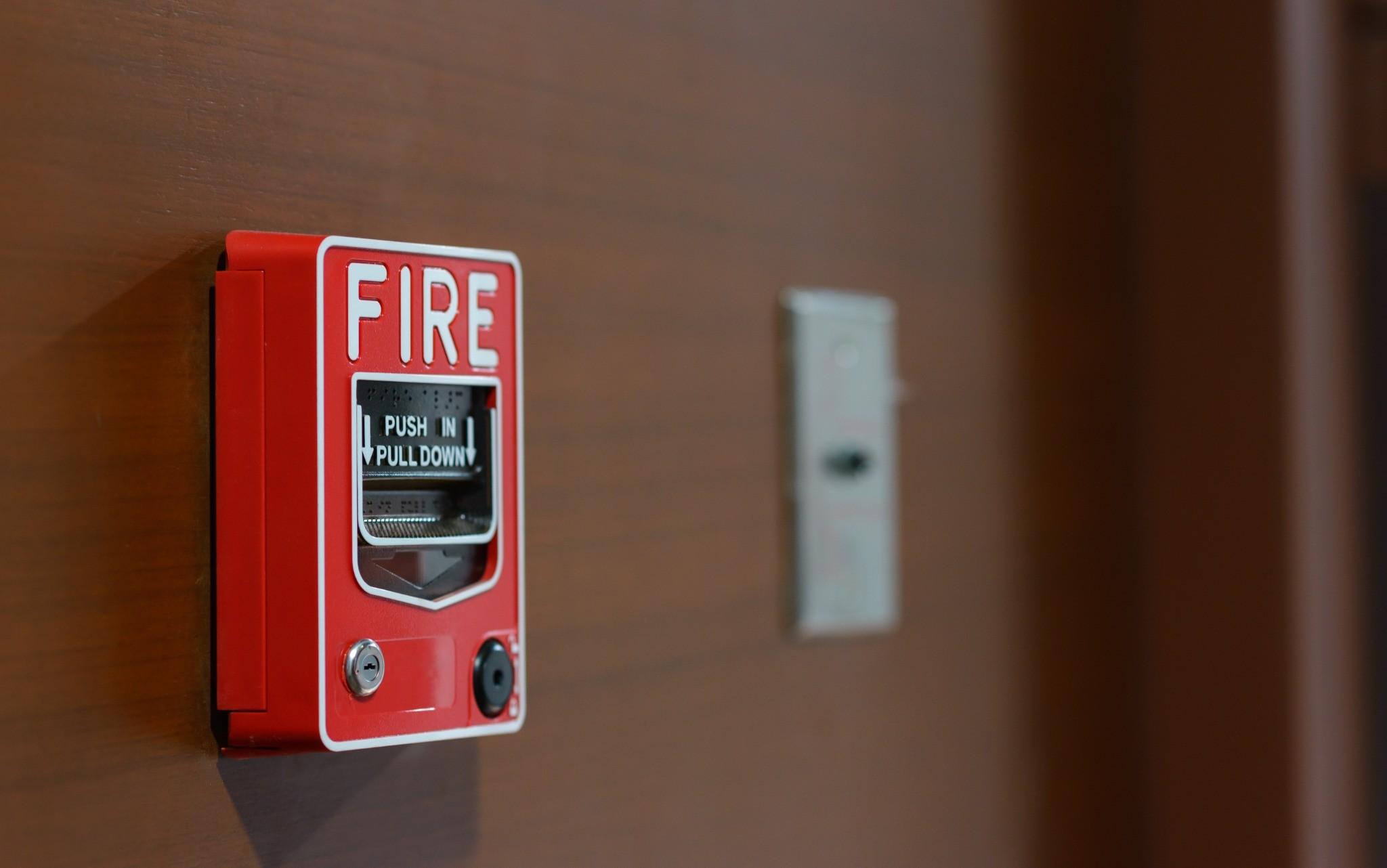 Commercial manual fire alarm pull station mounted on a wall