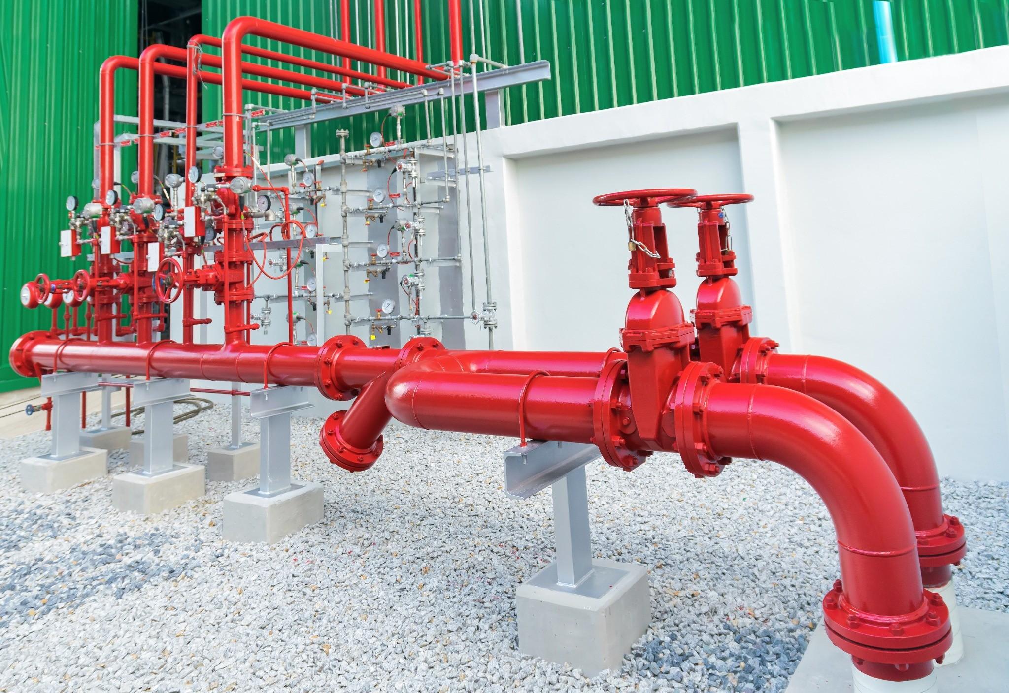 Fire sprinkler piping and control valves outside a commercial facility
