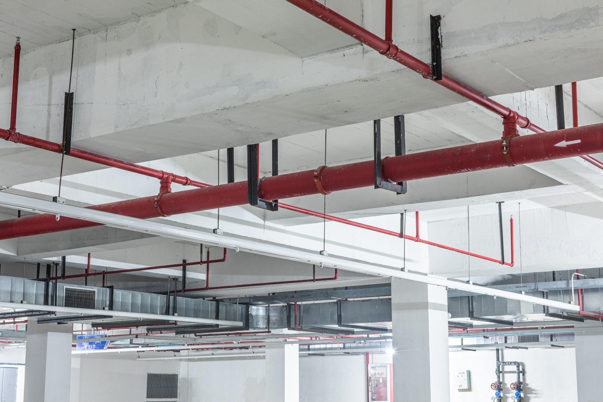 Overhead fire sprinkler piping protecting a commercial building
