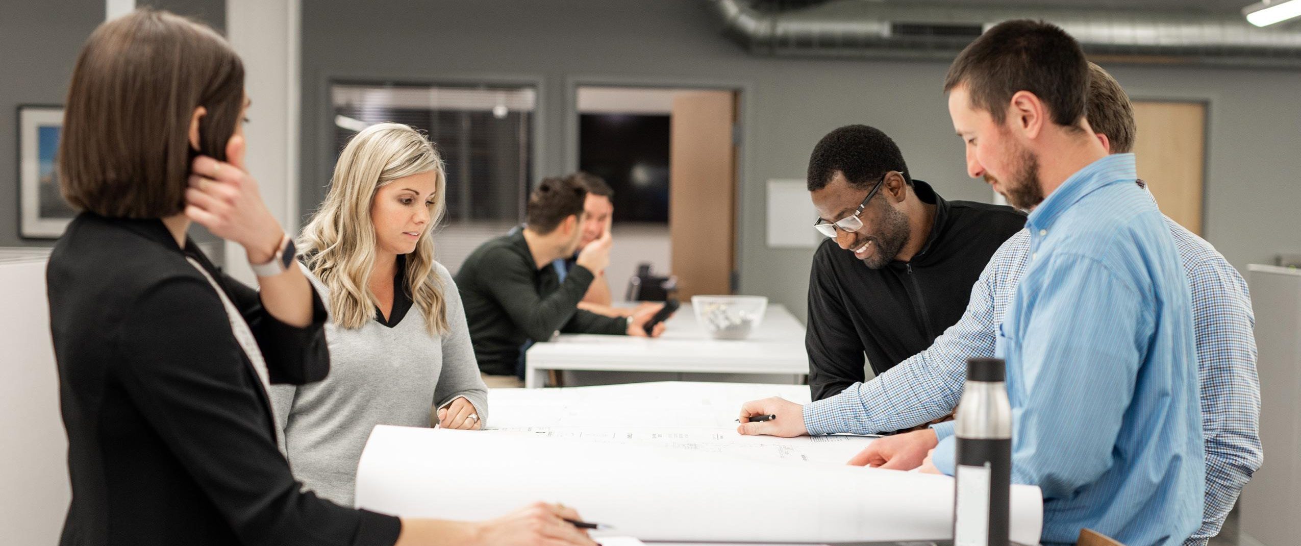 VFPG employees collaborating during a commercial fire protection project planning meeting